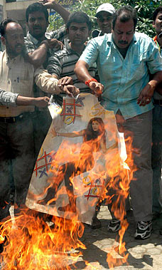 Demonstrators burning Shetty poster